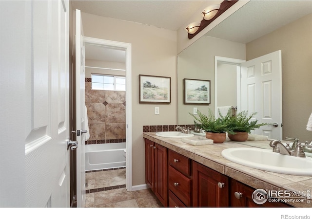 full bath featuring double vanity, a sink, and washtub / shower combination