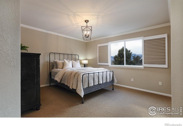 carpeted bedroom featuring baseboards, a chandelier, and crown molding