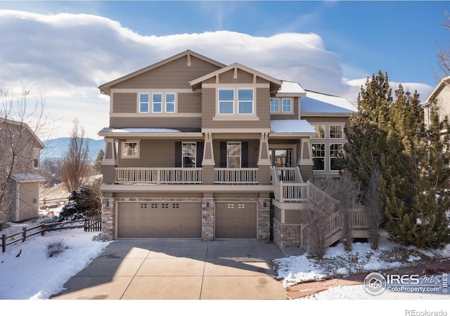 view of front of house with a garage, stone siding, covered porch, and concrete driveway