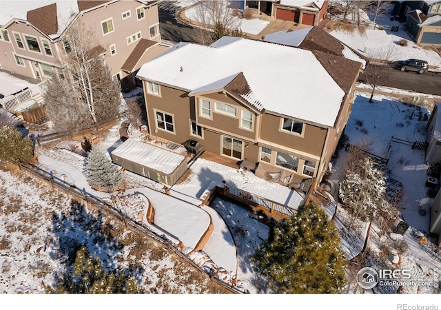 snowy aerial view featuring a residential view