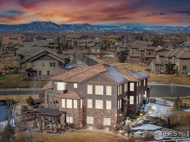 aerial view at dusk featuring a mountain view