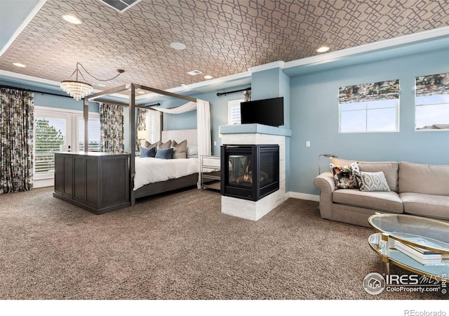 carpeted bedroom featuring crown molding and a multi sided fireplace