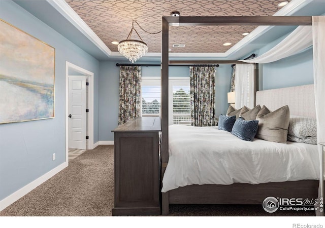 bedroom with a raised ceiling, an inviting chandelier, crown molding, and carpet floors