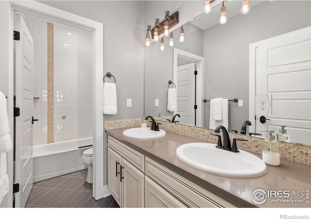 full bathroom featuring toilet, tile patterned floors,  shower combination, and vanity