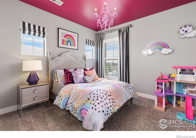 bedroom with carpet flooring and a notable chandelier