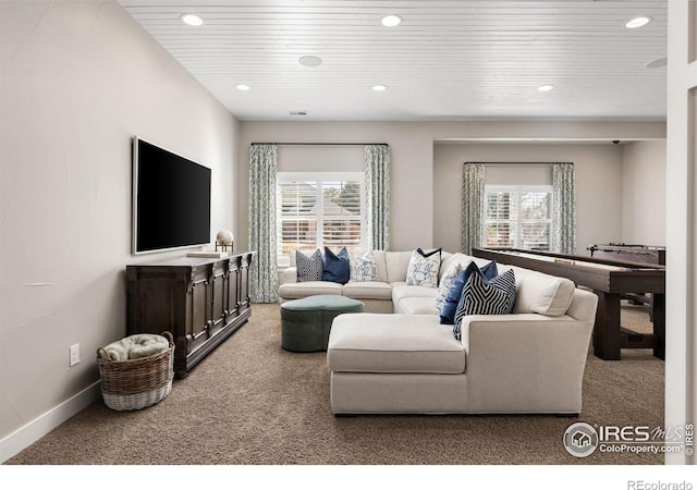 carpeted living room with wooden ceiling