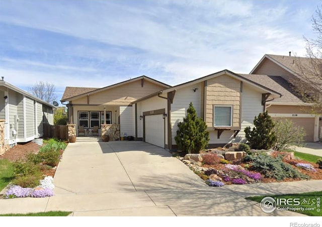 view of front facade with concrete driveway and an attached garage