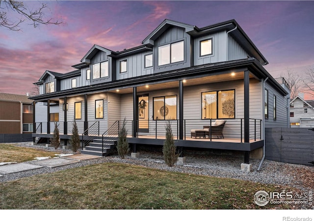 view of front of home featuring a porch, board and batten siding, and a front lawn