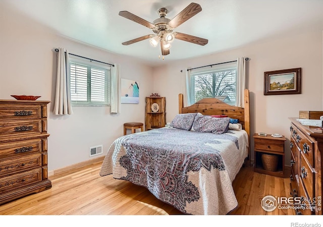 bedroom with ceiling fan and light hardwood / wood-style flooring