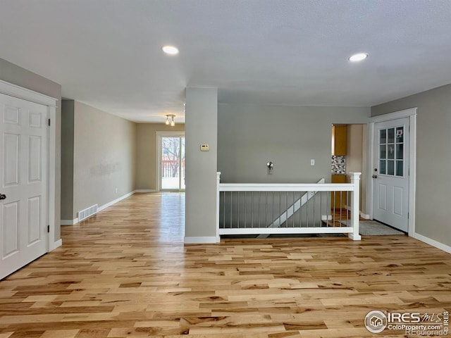 spare room with light hardwood / wood-style flooring