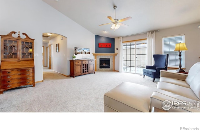 living room with high vaulted ceiling, light colored carpet, and ceiling fan