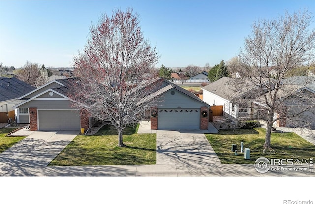 single story home featuring brick siding, a front lawn, an attached garage, and driveway