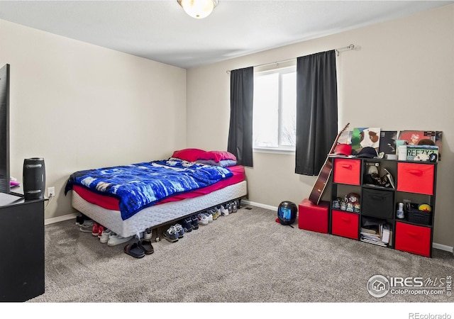 bedroom featuring carpet and baseboards