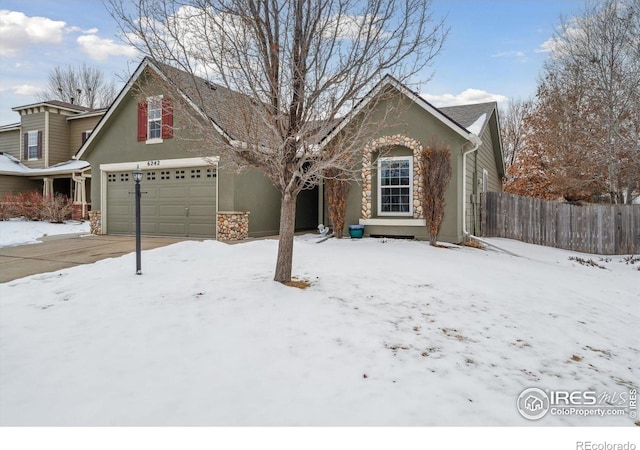 view of front of home with stone siding, fence, and stucco siding