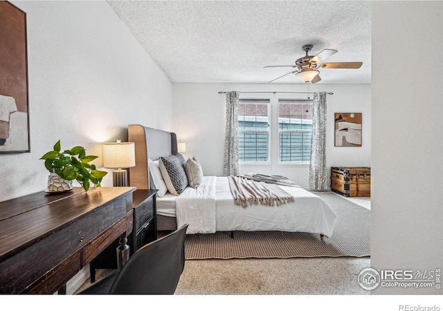 bedroom featuring a ceiling fan and a textured ceiling