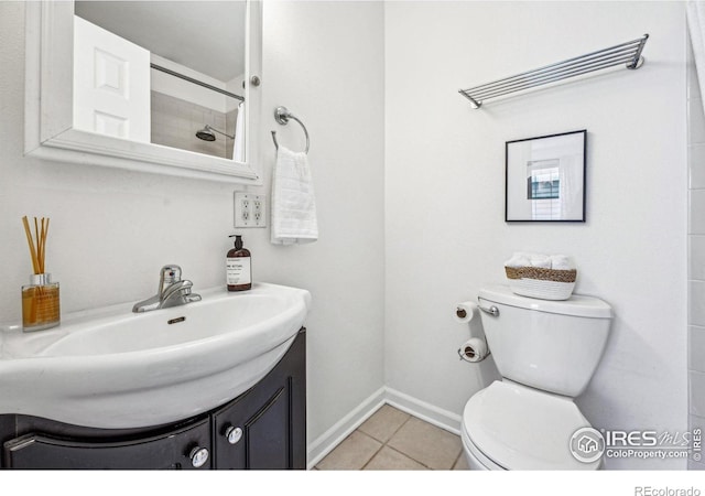 full bathroom featuring tile patterned floors, toilet, vanity, baseboards, and walk in shower