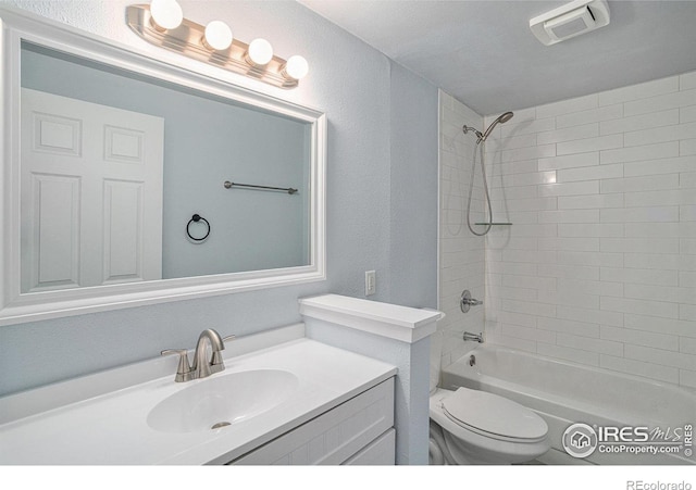 bathroom featuring vanity, toilet, visible vents, and shower / bathing tub combination