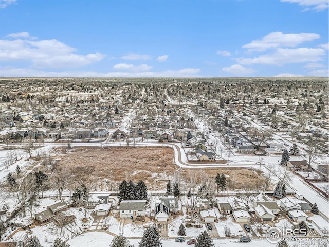 snowy aerial view featuring a residential view