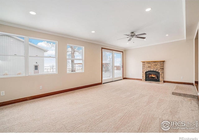 unfurnished living room featuring baseboards, ornamental molding, and carpet flooring