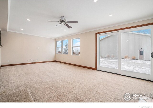 spare room featuring light carpet, recessed lighting, baseboards, and ornamental molding