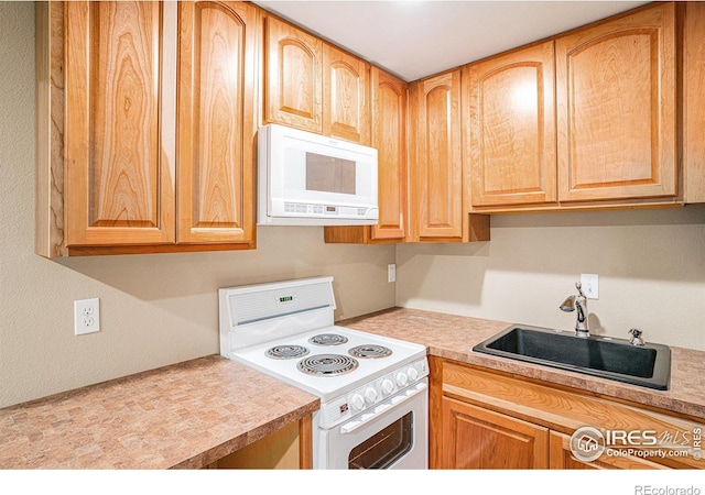 kitchen featuring a sink, brown cabinets, light countertops, and electric stove