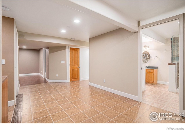 unfurnished room with light tile patterned floors, baseboards, beam ceiling, and recessed lighting