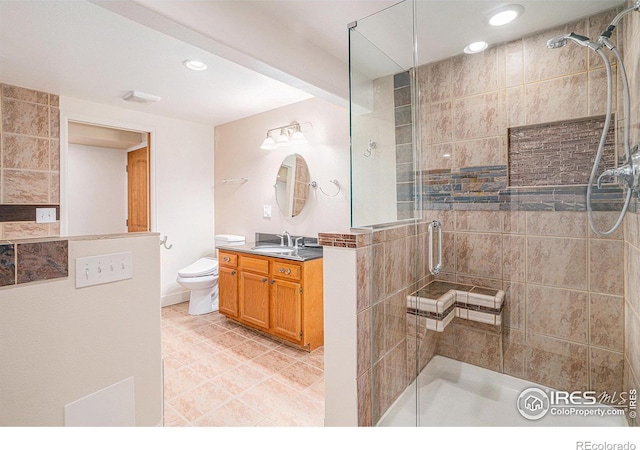 bathroom with vanity, recessed lighting, tile patterned flooring, toilet, and a shower stall