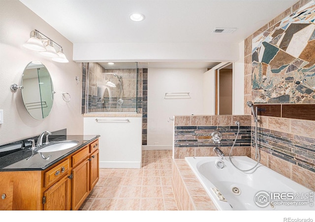 bathroom with vanity, visible vents, tile patterned flooring, tiled shower, and a whirlpool tub