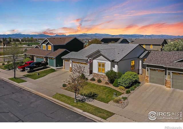 view of front facade with driveway, a mountain view, and an attached garage