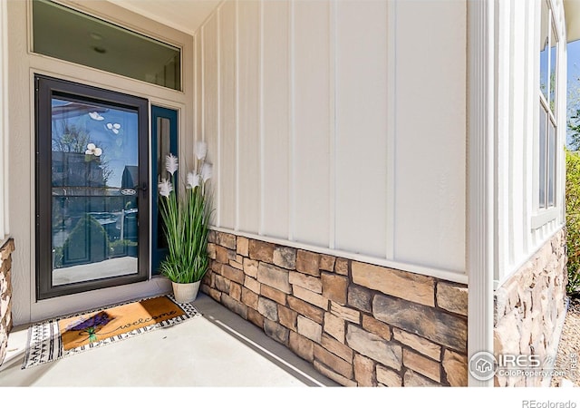 property entrance featuring stone siding