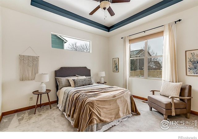 bedroom featuring light colored carpet, visible vents, baseboards, and ceiling fan