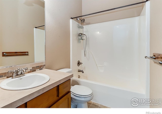 full bathroom featuring toilet, tile patterned flooring, vanity, decorative backsplash, and washtub / shower combination