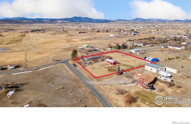 birds eye view of property with a mountain view and a rural view