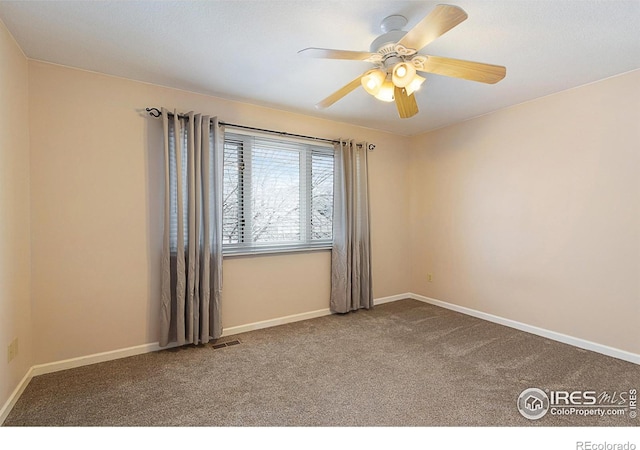 unfurnished room featuring carpet floors, visible vents, ceiling fan, and baseboards