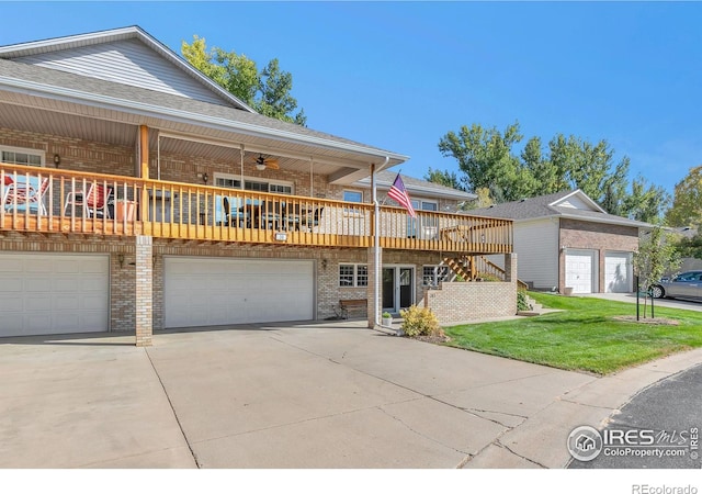 view of front of property with a garage, concrete driveway, stairway, a wooden deck, and brick siding