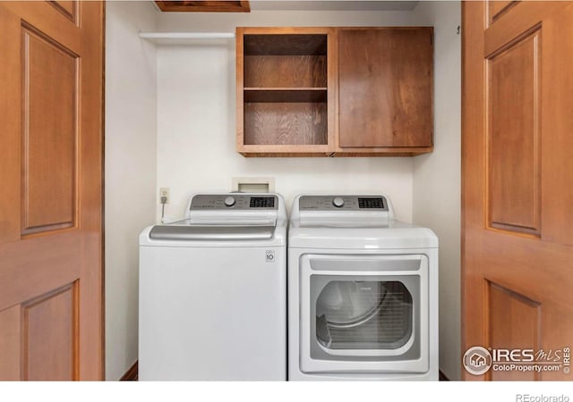 laundry area with cabinet space and washing machine and clothes dryer