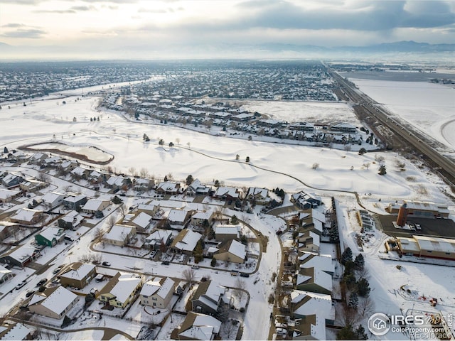 snowy aerial view with a residential view