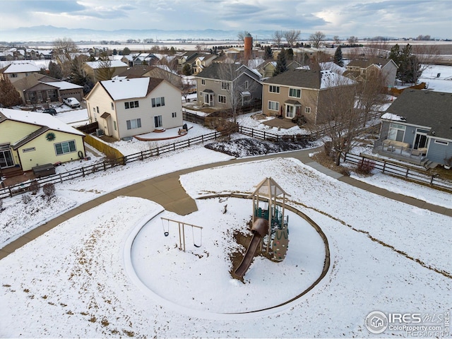 snowy aerial view featuring a residential view