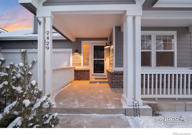 exterior entry at dusk with a garage