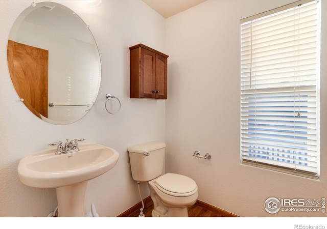 bathroom with toilet and baseboards