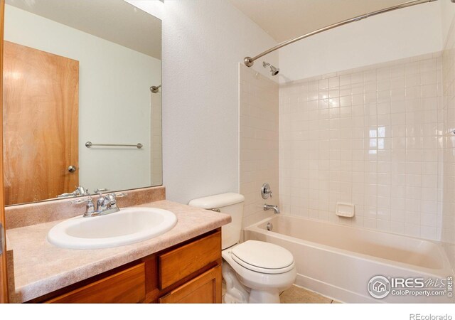 bathroom with toilet, tub / shower combination, and vanity