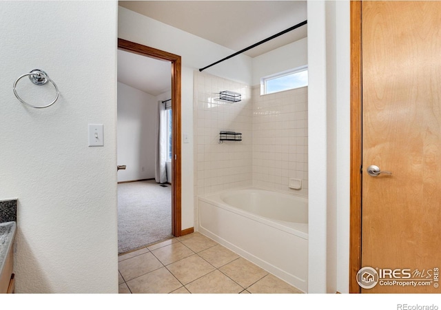 full bath featuring  shower combination, tile patterned flooring, and baseboards