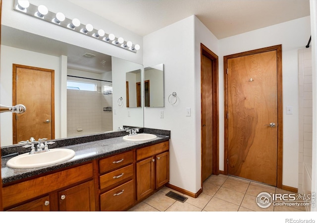 full bath with double vanity, visible vents, a sink, and tile patterned floors