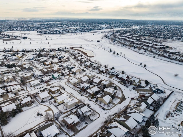 snowy aerial view with a residential view