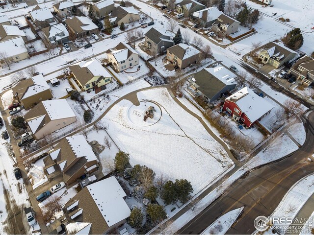 snowy aerial view featuring a residential view