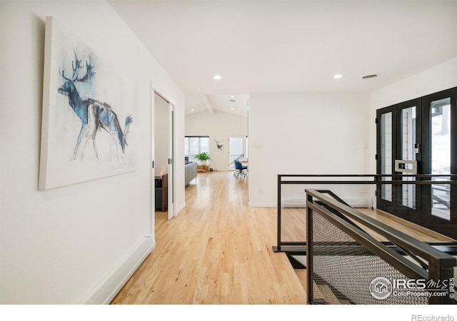 hallway featuring french doors, recessed lighting, vaulted ceiling, light wood-type flooring, and baseboards