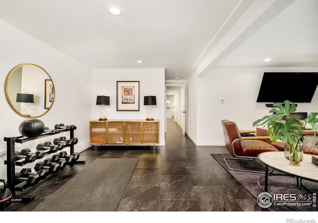 foyer entrance with baseboards and recessed lighting