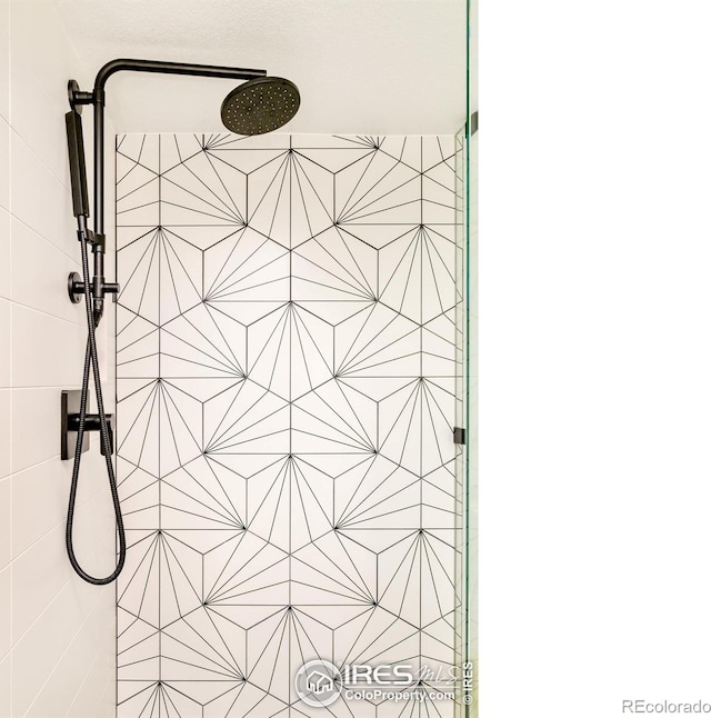 interior details featuring a tile shower