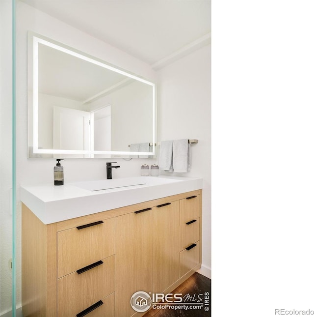 bathroom featuring vanity and wood finished floors