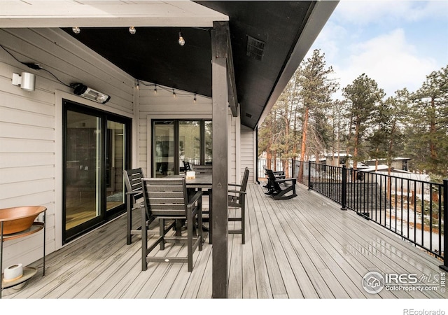 wooden deck with outdoor dining space